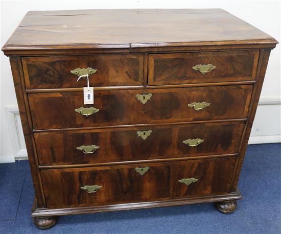 A George II banded walnut chest fitted two short drawers and three graduated long drawers, on bun feet, 101c wide